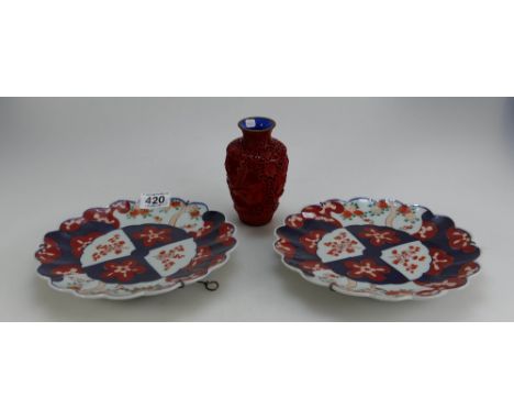 Two unmarked Japanese export ware decorative wall plates together with red lacquered vase (3)