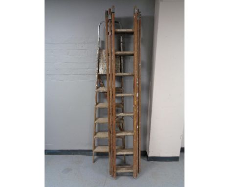 A set of folding wooden ladders together with a wooden triple section extension ladder 