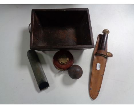 A box of William Rogers knife in leather sheath, vintage tape measure, cased thermometer, antique cannon ball 