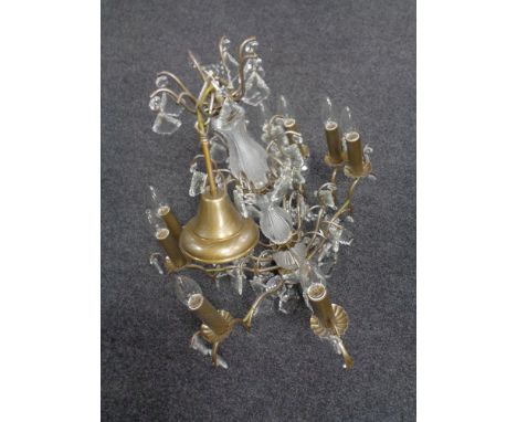A decorative metal and glass eight branch chandelier with crystal drops 