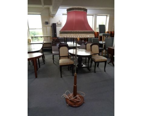 An early twentieth century standard lamp with shade with brass feet 