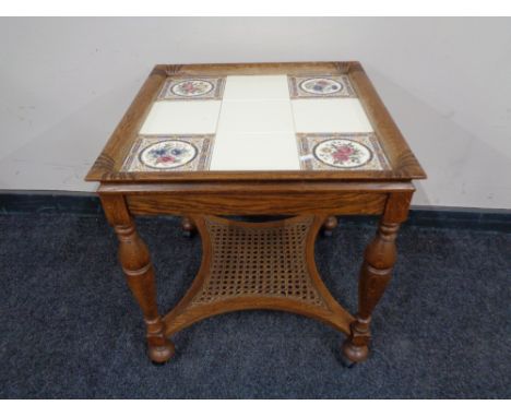 A continental oak tiled table with begere undershelf together with a further pair of tiled lamp tables 