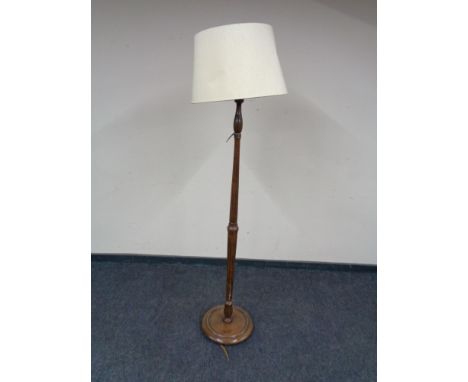 An early twentieth century oak standard lamp with shade 