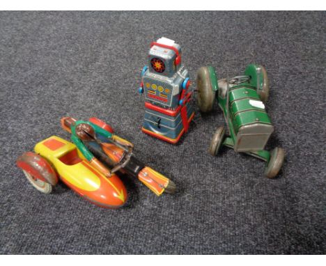 A mid century tin plated tractor together with a tin plated robot and motorbike with sidecar 