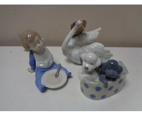 Three Nao figures - Boy, swan and puppies in basket 