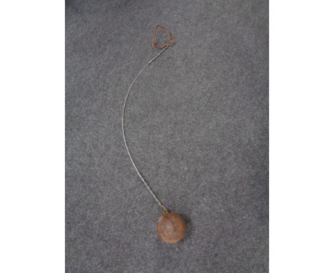 A vintage throwing hammer on wire 
