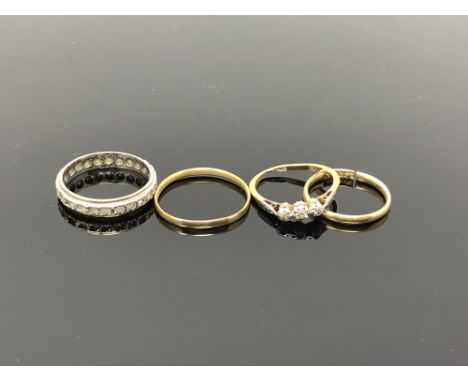 An 18ct gold band ring (broken), and three other rings indistinctly stamped CONDITION REPORT: 18ct ring - 1.7g. Three other r