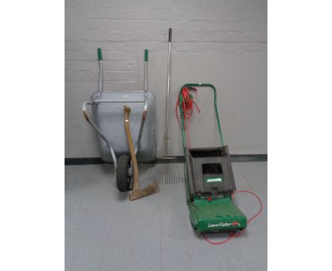 A metal wheel barrow together with a qualcast electric lawn mower, garden rake and axe 
