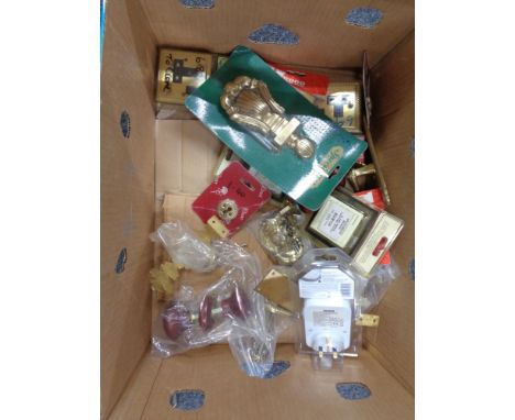 A box of wooden and brass door furniture, socket covers, timer switch