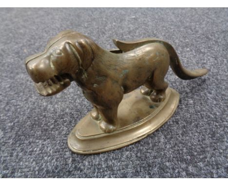 A 1930's brass nut cracker in the form of a dog 