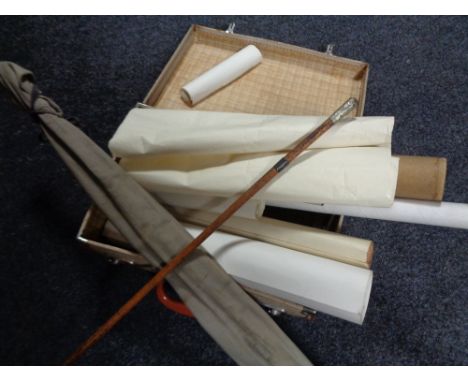 A vintage luggage case of swagger stick, assorted rolled maps and prints, two piece fishing rod etc 