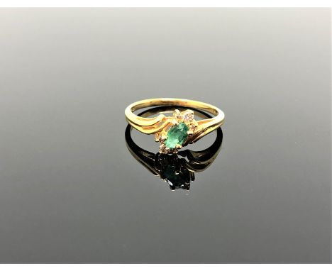 A 14ct gold emerald and diamond ring, size N