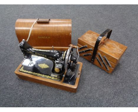 An oak cased vintage sewing machine together with a concertina sewing box  CONDITION REPORT: This item has not been tested.