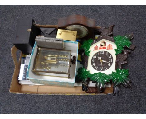 A box of clocks, quarts cuckoo clock, mid century mantle clock, vintage cameras etc 