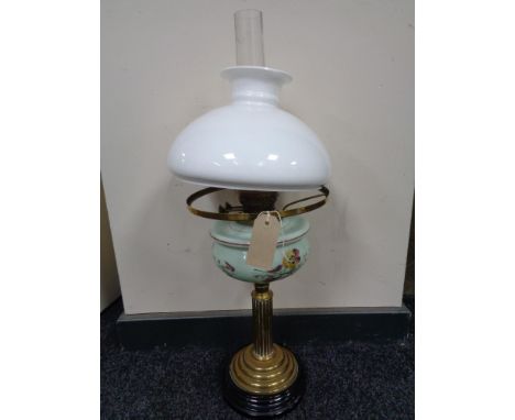 An antique brass Corinthian column oil lamp with hand painted glass reservoir, chimney and shade  CONDITION REPORT: This lamp