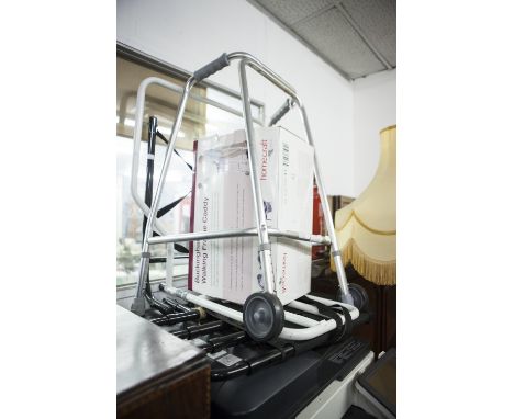 A COLLECTION OF MODERN WALKING AIDES TO INCLUDE A ZIMMER FRAME AND CADDY, CRUTCHES, ETC