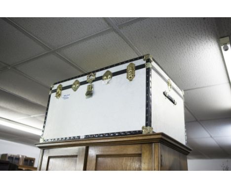 A LARGE METAL BOUND FIBRE CABIN TRUNK 