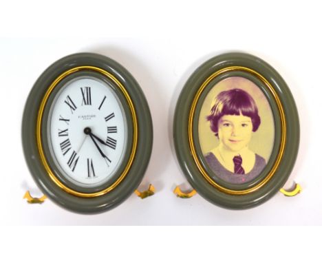 Cartier, Paris; a small grey enamelled alarm clock, the dial set with Roman numerals and a matching Les Must de Cartier photo