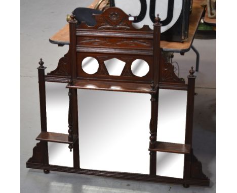 An Edwardian mahogany over mantel mirror, foliate carved pediment above six bevel edged plates, width 104cm.