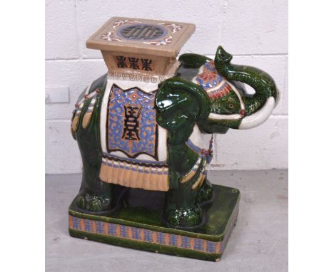 A modern decorative green ground ceramic elephant, height approx 60cm.
