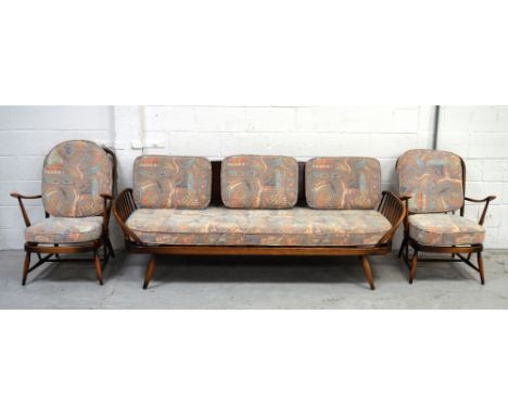 An Ercol stick back sofa, width 204cm and a pair of matching armchairs (3).