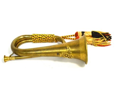 A brass military bugle mounted with worn military plaque.