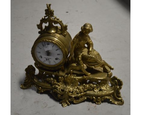 A decorative brass figural eight day mantel clock, the dial set with Roman numerals and indistinctly signed, width 36cm.
