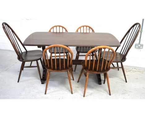 An Ercol refectory style dining table raised on twin end slab supports with conjoining stretcher, length approx 152cm, a set 