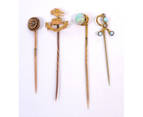 Four yellow metal stick pins to include an example set with an opal and one set with a small diamond (4).