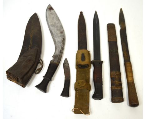 A WWI period bayonet with metal scabbard and canvas belt loop, a kukri knife in leather scabbard and a further knife with bou