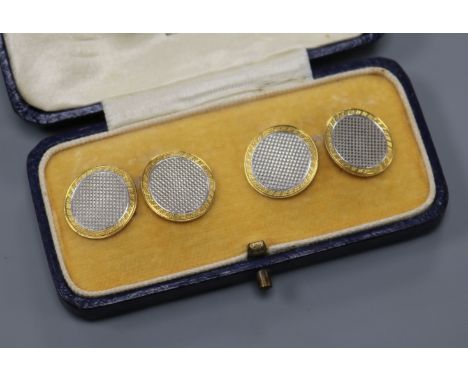A cased pair of engine turned 18ct gold and platinum circular cufflinks, gross 8.2 grams.