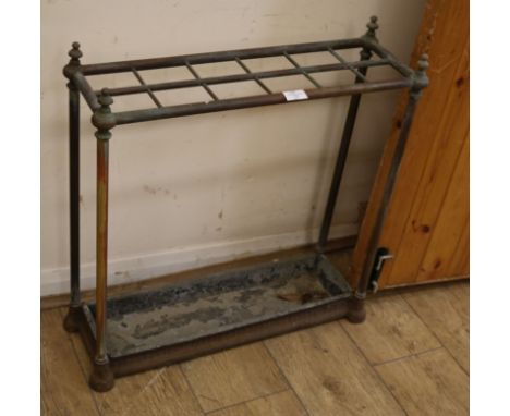 A twelve section brass and iron stick stand W.64cm