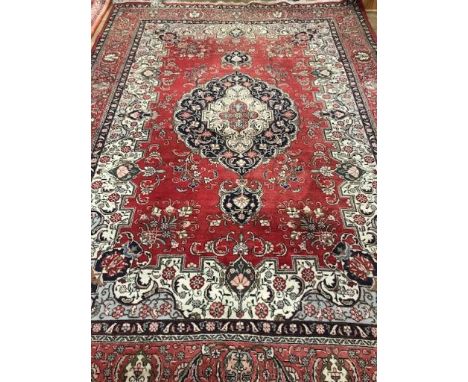 A Persian design red ground carpet 250 x 350cm