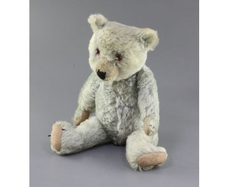 A 1930's blue Chiltern teddy bear, faded, 20in.