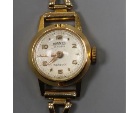 A lady's 18ct gold Roamer manual wind wrist watch, on a 9ct gold bracelet.
