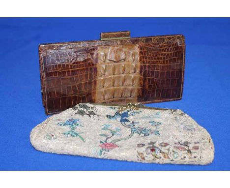 LADY'S VINTAGE BROWN CROCODILE PURSE
with crocodile mirror and coin purse in the fitted interior; together with an early 20th