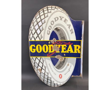 A Continental Goodyear tyre-shaped double sided enamel sign with hanging flange, 22 x 34". 