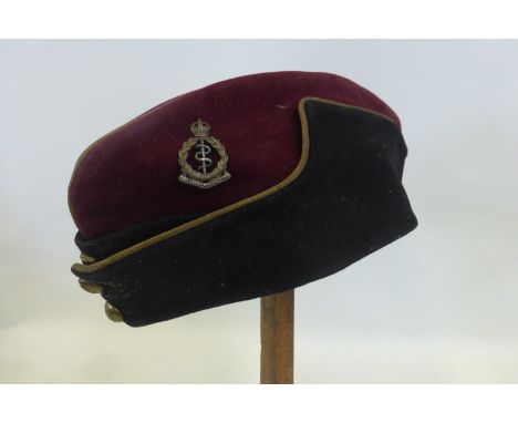 A Royal Army Medical Corps officer's side cap with a silver and gilt cap badge.