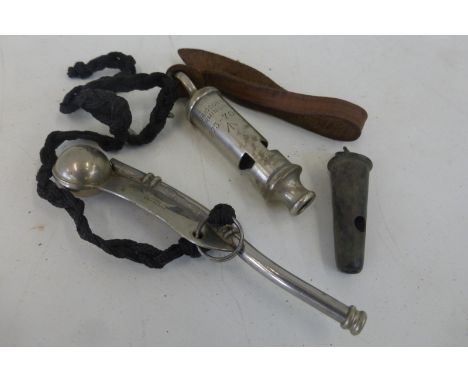 A military marked Army whistle with a military marked Naval Bosun's whistle and an early Beaufort whistle.