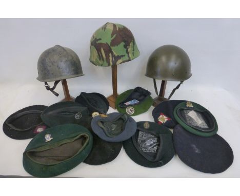 Three plastic military helmet liners and eleven military berets including R.A.F., Royal Irish Rangers, Royal Green Jackets et