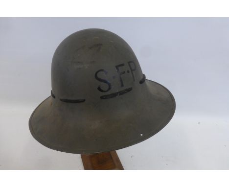 A WW2 Civil Defence SFP (Special Fire Patrol) helmet, dated 1941 on both the helmet and liner.