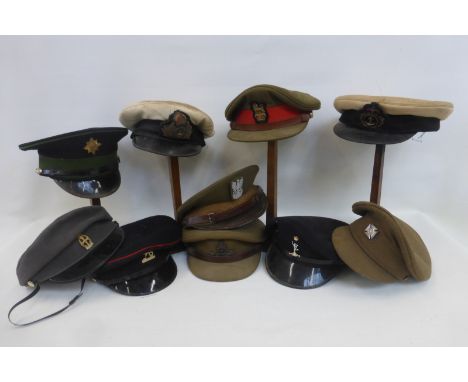 A box of ten military caps including the Irish guards, the Royal Artillery, the Royal Navy, the Royal Fleet Auxiliary, Queen 