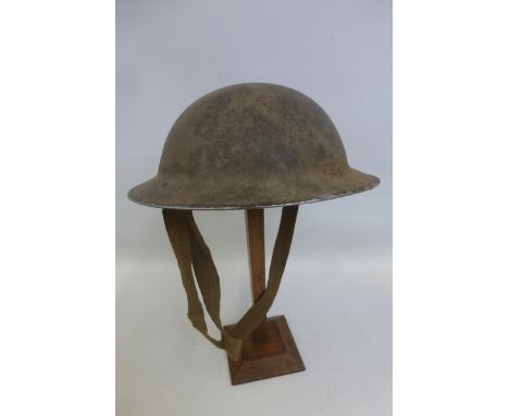 A WW2 British Army helmet dated 1940 complete with liner and chin strap.