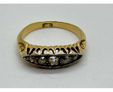 An Antique Style Five Stone Diamond Ring, of boat form, the graduated brilliant cut stones within decorative scroll setting (