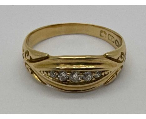 An Antique Five Stone Diamond Ring, of boat form, the graduated brilliant cut stones between decorative reeded setting and sc