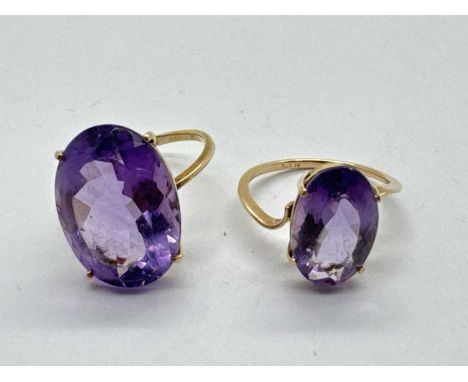 An Amethyst Set Dress Ring, oval claw set to centre, between scrolling shoulders and dainty band stamped "14K" (finger size K