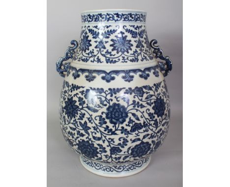 A LARGE CHINESE MING STYLE BLUE & WHITE PORCELAIN HU VASE, with moulded sprig handles, the base with a Qianlong seal mark, 15