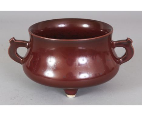 A CHINESE IRON RUST TRIPOD PORCELAIN CENSER, the base with a Qianlong seal mark, 7in wide including handles & 4.6in diameter 