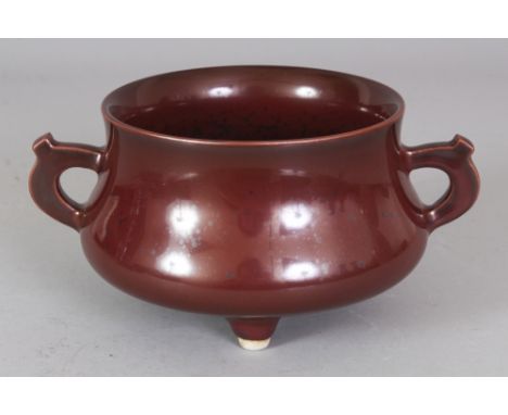 A CHINESE IRON RUST TRIPOD PORCELAIN CENSER, the base with a Qianlong seal mark, 7in wide including handles & 4.6in diameter 