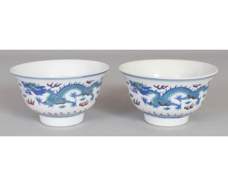 A PAIR OF CHINESE DOUCAI PORCELAIN DRAGON BOWLS, each base with a Jingezhen seal mark, 4.3in diameter & 2.5in high.